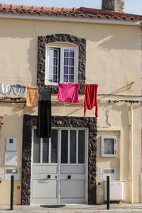 Low angle view of clothes drying outside building