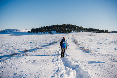 Man hiking in snowy mountain in a sunny day. nature. winter season