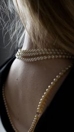 Close-up of woman with pearl jewelry