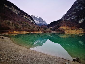 Scenic view of lake and mountains against sky