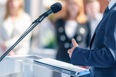 Midsection of man playing drum