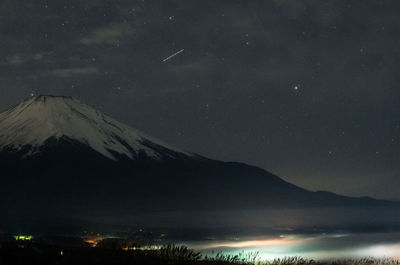 Scenic view of mountains against sky at night