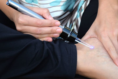 Midsection of woman holding hands