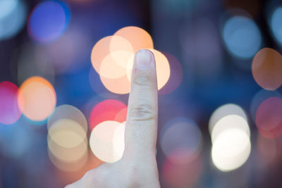 Defocused image of hand holding illuminated lights