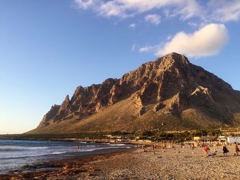 Scenic view of beach against blue sky during sunset