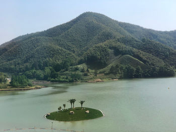 Scenic view of lake and mountains against sky