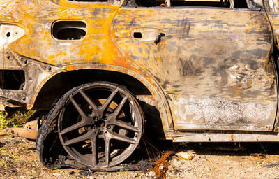 Old rusty car on field