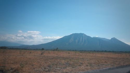 Scenic view of landscape and mountains against sky