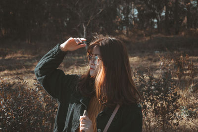 Full length of young woman standing outdoors