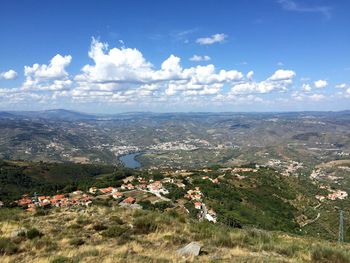 View of cityscape against cloudy sky