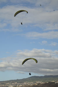 People paragliding against sky