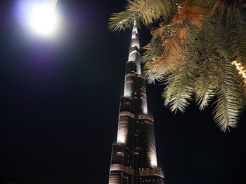 Low angle view of illuminated tower against sky at night