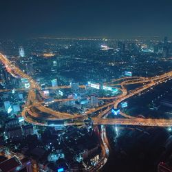 High angle view of illuminated buildings in city at night