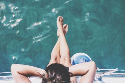 High angle view of woman sitting on boat over sea