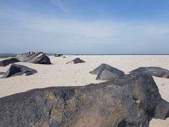 Rocks on beach against sky