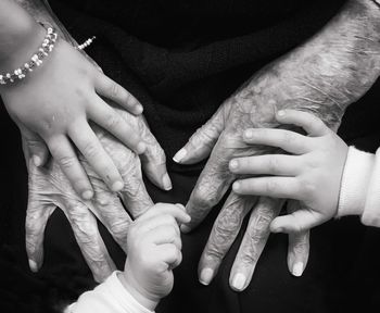 Midsection of couple holding hands