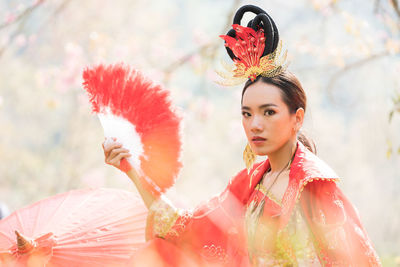 Portrait of woman with red flowers