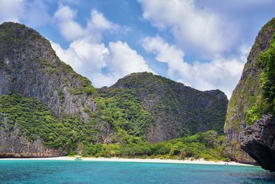 Scenic view of sea and mountains against sky