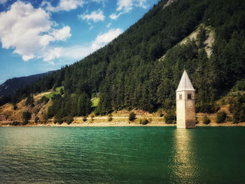 Scenic view of lake by building against sky