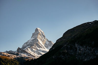Scenic view of snowcapped mountains against clear sky