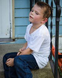 Boy sitting outdoors