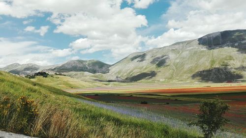 Scenic view of mountains against cloudy sky