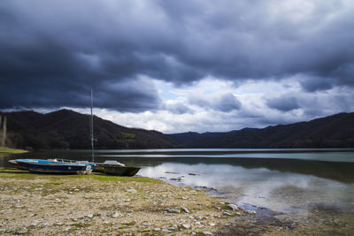 Scenic view of lake against cloudy sky