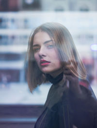 Side view of young woman standing outdoors