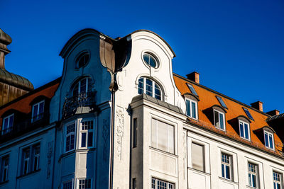 Low angle view of buildings against blue sky