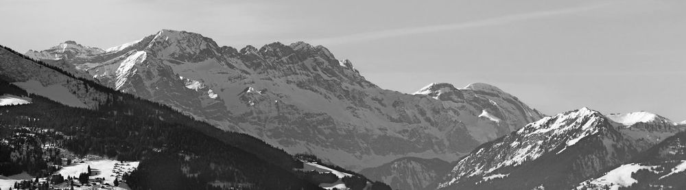 Panoramic view of snowcapped mountains against sky