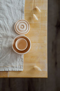 Ceramic bowls in the shape of number eight on a wooden table