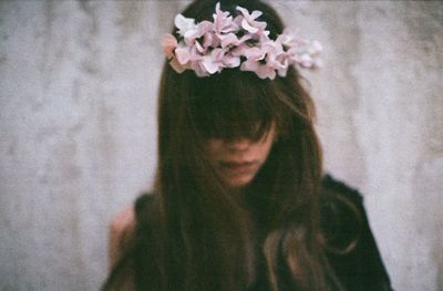 Digital composite image of woman wearing flower wreath