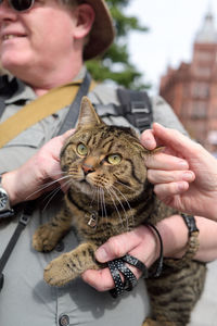 Midsection of woman holding cat