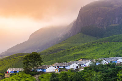 Houses on mountain against sky