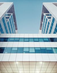 Low angle view of modern building against clear blue sky