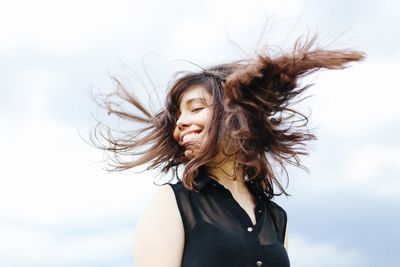 Portrait of beautiful woman against sky