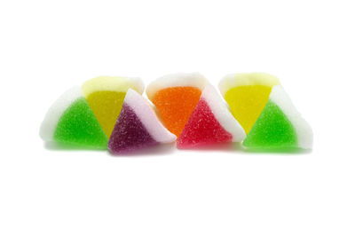 Close-up of multi colored candies against white background