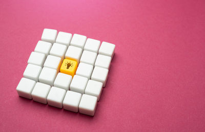 High angle view of dices on yellow background