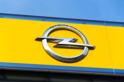 Close-up of yellow bicycle against blue sky