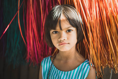 Portrait of smiling girl by curtain