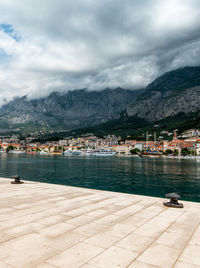 Scenic view of lake by buildings against sky