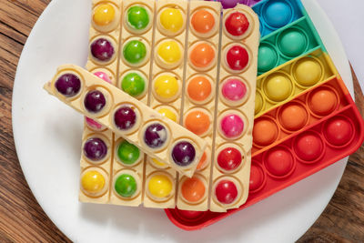 High angle view of candies in plate on table