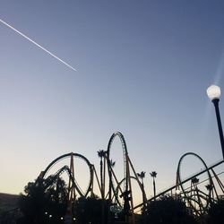 Low angle view of rollercoaster against clear sky