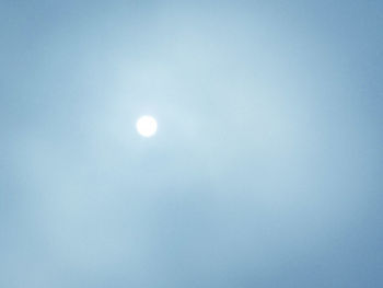 Low angle view of moon against clear blue sky