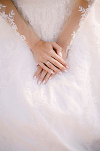 Midsection of woman holding wedding rings