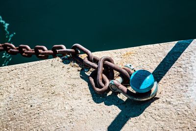 High angle view of chain on rope