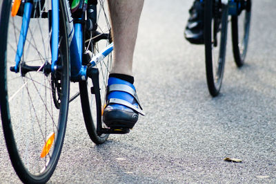 Low section of athletes cycling on road during race