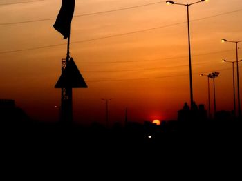 Silhouette building against sky during sunset