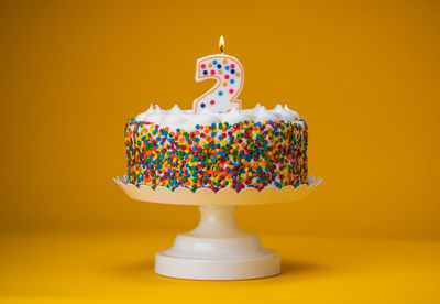 Close-up of cake against colored background