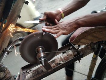 Close-up of person sharpening knife 